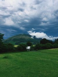 Scenic view of landscape against cloudy sky