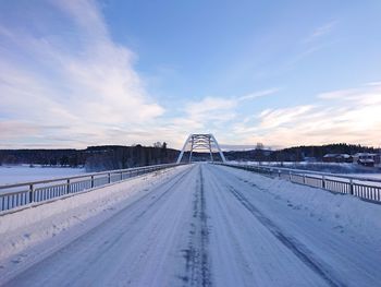 Snow covered road against sky