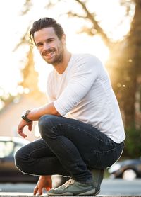 Portrait of young man sitting outdoors