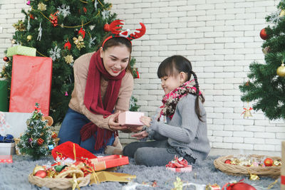 Women sitting on christmas tree