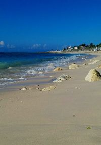 Scenic view of beach against blue sky