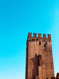 Low angle view of historic building against blue sky