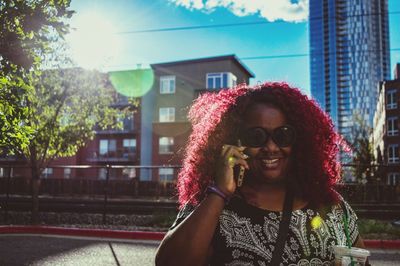 Portrait of smiling woman against built structure