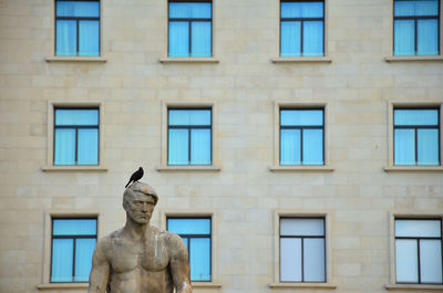 Low angle view of statue against building