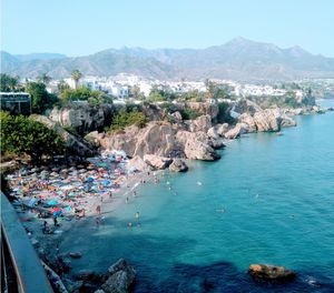 High angle view of sea and mountains against clear sky