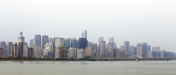 Modern buildings in city against clear sky