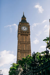 Low angle view of clock tower against sky