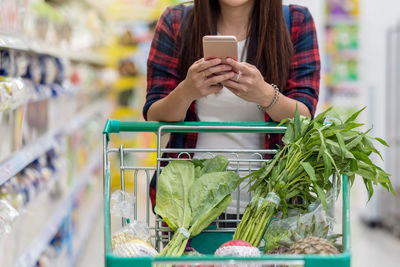 Midsection of woman using mobile phone