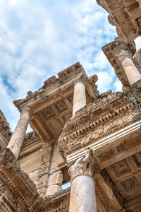 Low angle view of old temple against cloudy sky