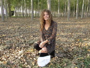 Teenage girl standing in forest