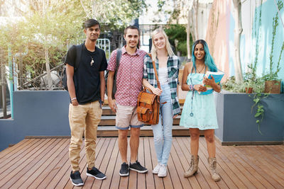 Portrait of smiling friends at campus