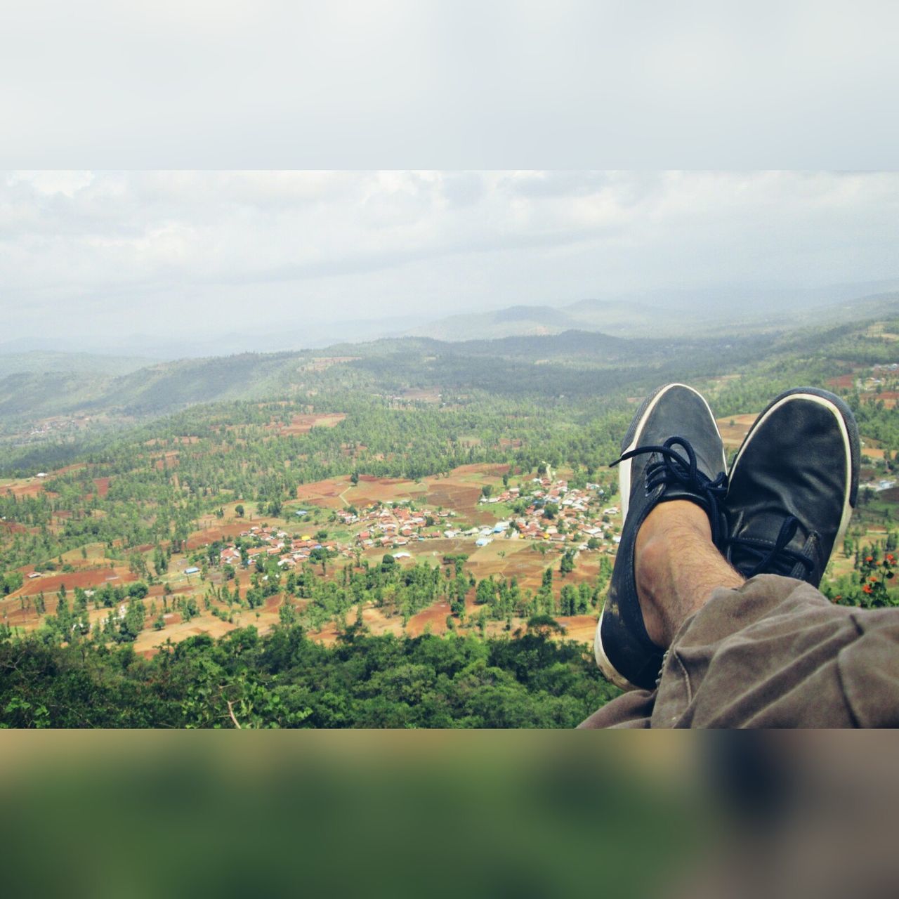 shoe, low section, human leg, personal perspective, real people, one person, day, landscape, nature, human body part, sky, lifestyles, cloud - sky, mountain, outdoors, scenics, men, beauty in nature, grass, tree, people