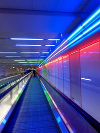 Illuminated moving walkway in building