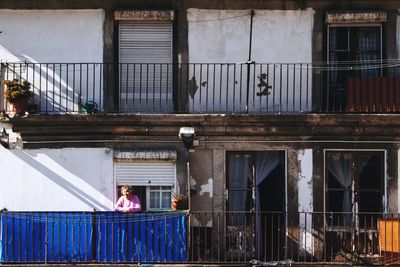 People working on railing of building