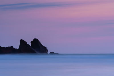 Scenic view of sea against sky at sunset