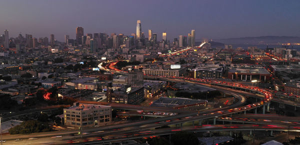 High angle view of illuminated city buildings against sky