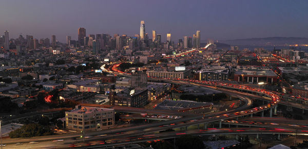 High angle view of illuminated city buildings against sky