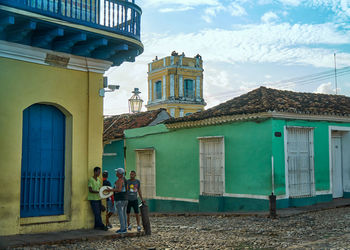 People in front of building against sky