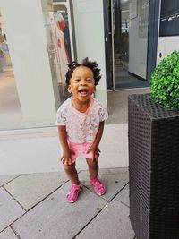 Portrait of a smiling girl standing outdoors