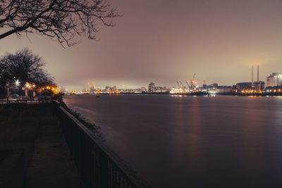 Thames barrier, tate lyle sugar factory and city in the distance on a foggy december night