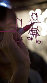 Close-up of hand holding illuminated light painting