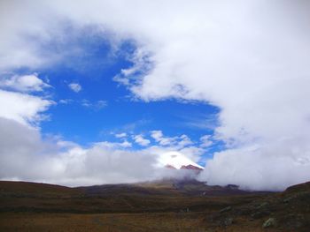 Scenic view of mountains against cloudy sky