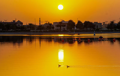 Scenic view of river against sky during sunset