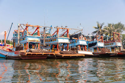 Wooden colorful fishing boats docking at maeklong river port in thailand