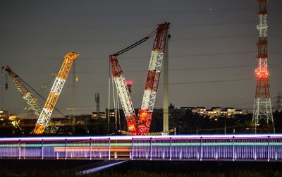 Light trails in city against sky at night
