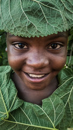 Close-up of a young girl with leaves