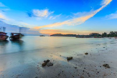 Scenic view of beach against sky during sunset