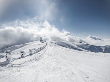 Scenic view of snow covered mountain against sky