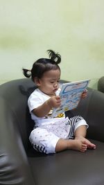 Cute girl sitting on mobile phone