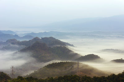 Fog on mountain mae moh lampang with high voltage power transmission towers.