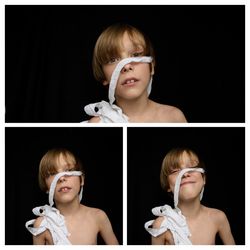 Portrait of boy against black background