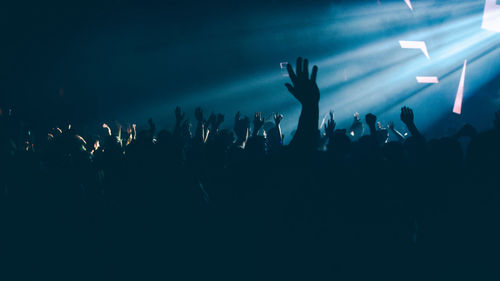 Crowd enjoying at illuminated musical concert at night