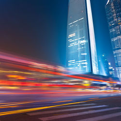 Light trails on street against sky at night