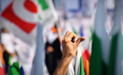 Cropped hand holding flag during event