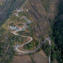 High angle view of road amidst trees on mountain