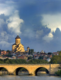 View of cityscape against cloudy sky