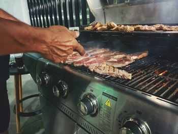 Man preparing food on barbecue grill