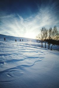 Scenic view of snow covered landscape against cloudy sky