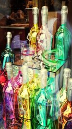 Multi colored bottles on display at store