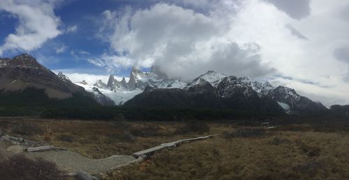 Scenic view of mountains against cloudy sky