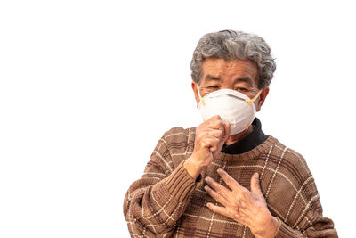 Portrait of man wearing mask against white background