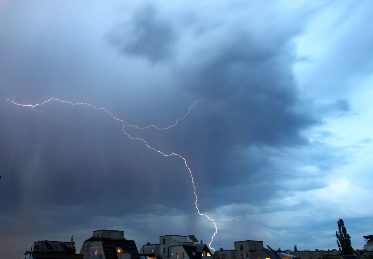 LOW ANGLE VIEW OF LIGHTNING OVER BUILDINGS