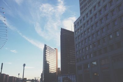 Low angle view of buildings against cloudy sky