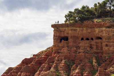 Low angle view of rock formation against sky