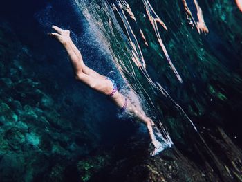 Full length of young woman in bikini swimming undersea