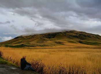 Scenic view of landscape against cloudy sky